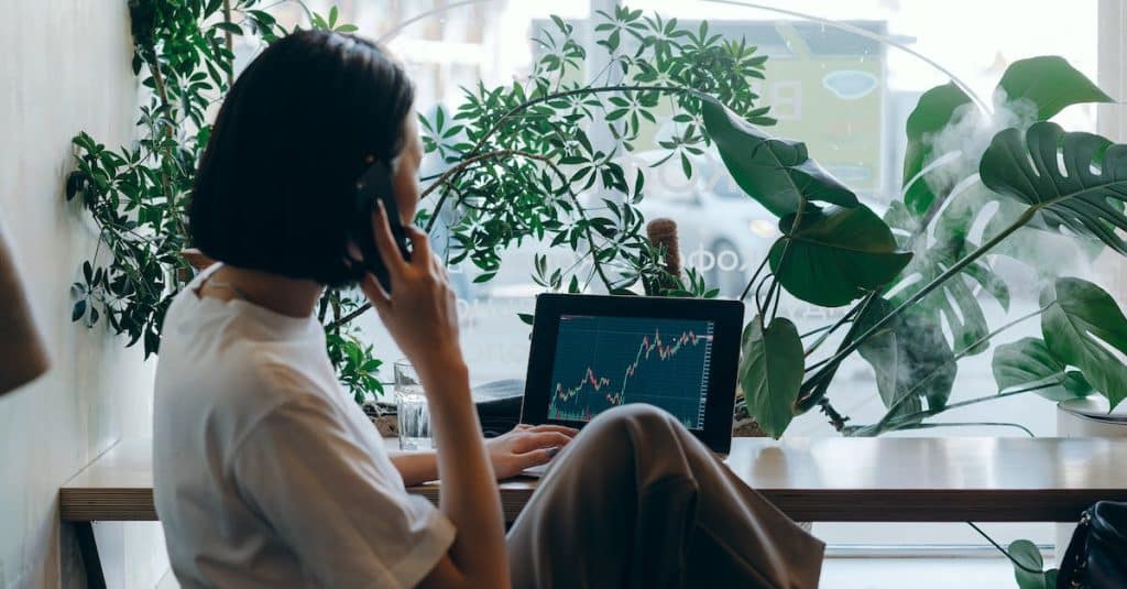 businesswoman-in-white-shirt-sitting-on-chair-while-having-phone-call