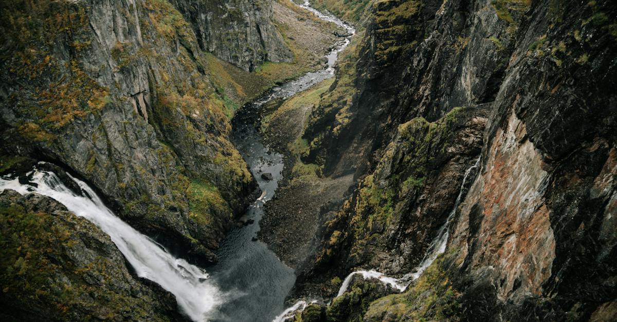 from-above-of-powerful-waterfall-falling-from-rocky-cliff-in-mountainous-ravine-in-highland