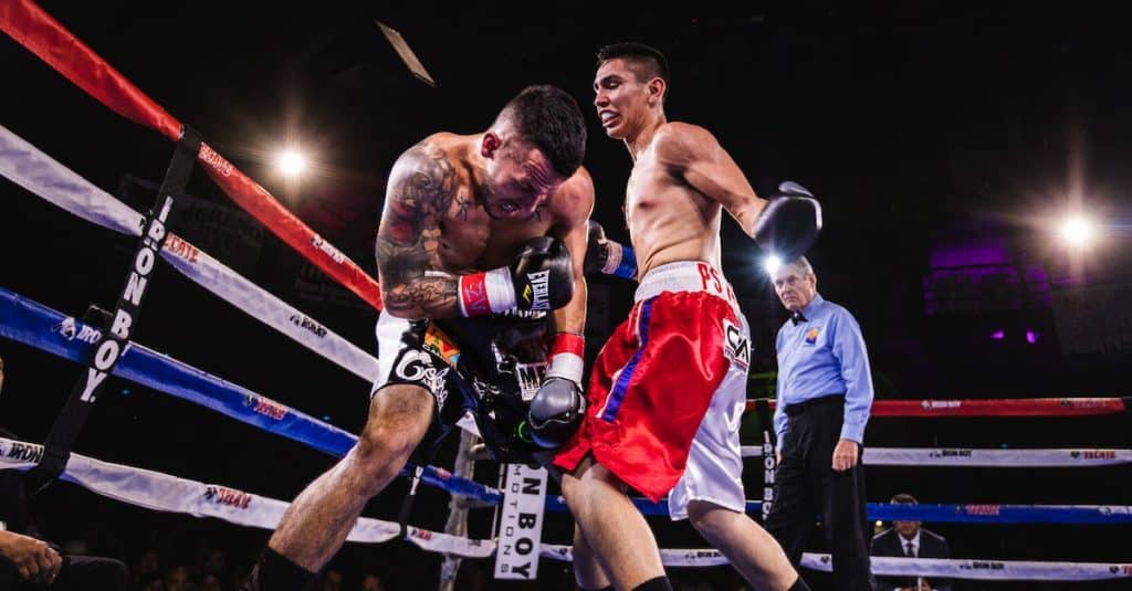 low-angle-photo-of-two-men-fighting-in-boxing-ring