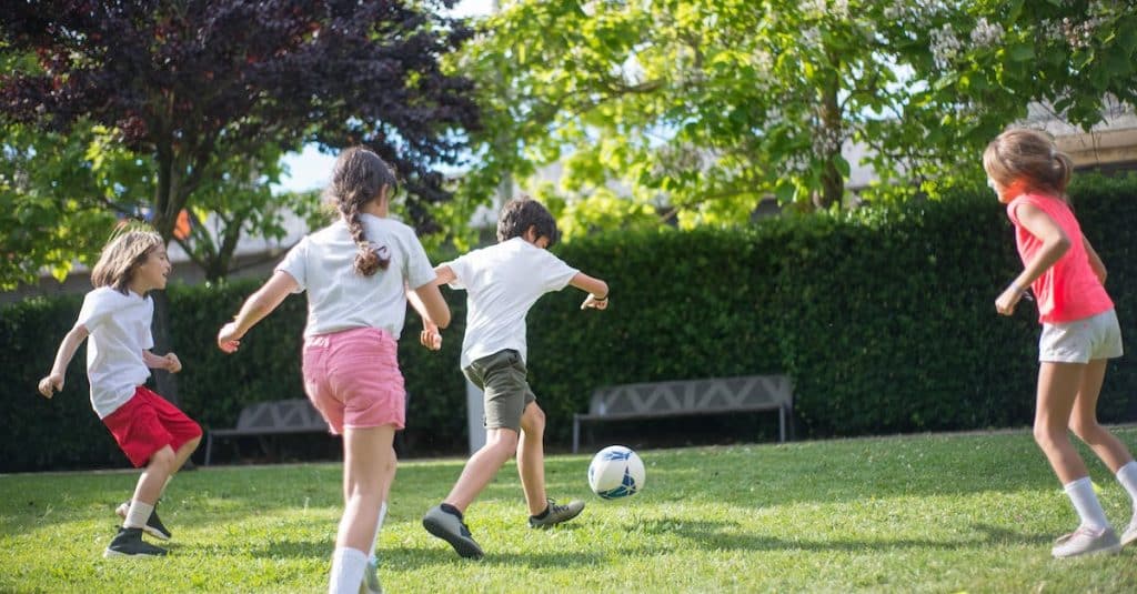 young-kids-playing-football-on-the-field