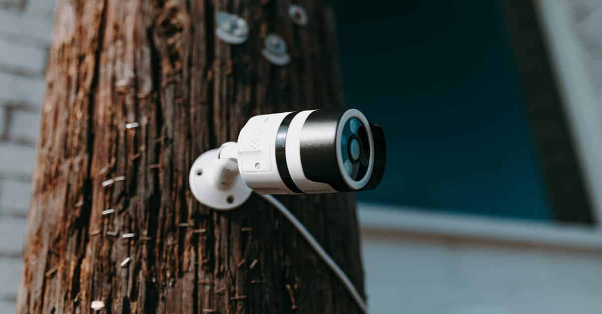 close-up-of-a-modern-security-camera-mounted-on-a-wooden-post-outdoors